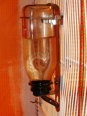 This is the large drinker from the side so you can see the holder that keeps it securely in place and the water flowing.
